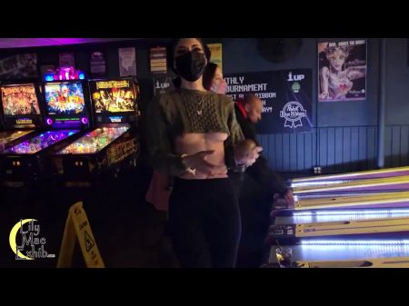Brazenly Showing Off Titties In A Engaged Arcade