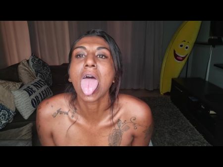 Desi se sienta en el sofá babeando mientras sobresale y mueve su lengua 